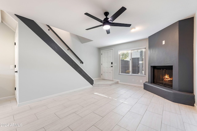 unfurnished living room with ceiling fan