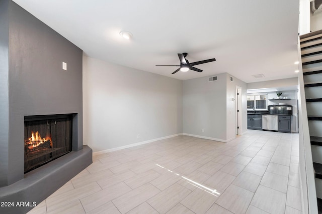 unfurnished living room with ceiling fan