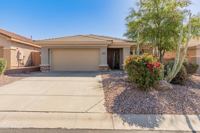 view of front of house featuring stucco siding, driveway, an attached garage, and a tiled roof