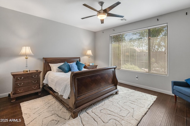 bedroom featuring a ceiling fan, visible vents, baseboards, and dark wood-style flooring