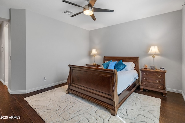 bedroom with hardwood / wood-style floors, baseboards, visible vents, and a ceiling fan