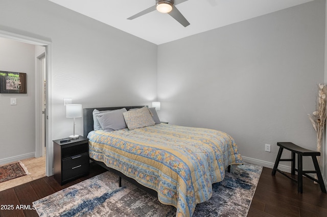 bedroom featuring baseboards, ceiling fan, and hardwood / wood-style flooring