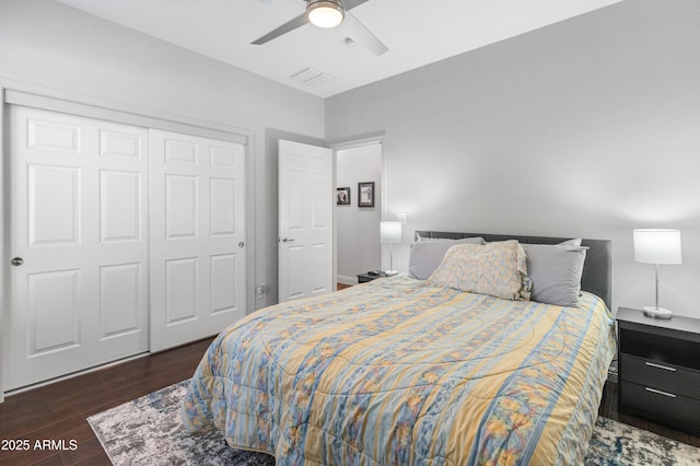 bedroom with a closet, a ceiling fan, visible vents, and dark wood-style flooring