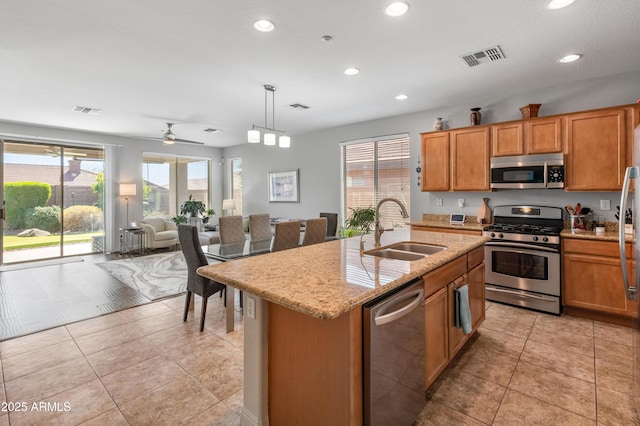 kitchen with visible vents, light stone countertops, recessed lighting, stainless steel appliances, and a sink