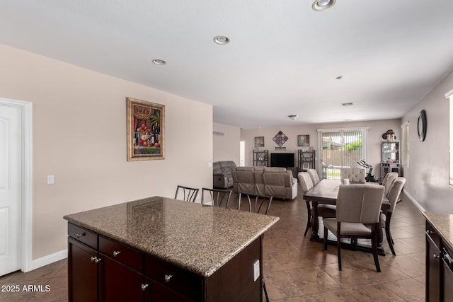kitchen featuring dark brown cabinets, baseboards, recessed lighting, and a kitchen island