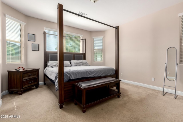 bedroom featuring light carpet, baseboards, and visible vents