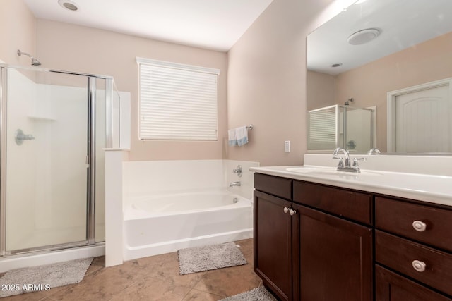 bathroom featuring a garden tub, a stall shower, tile patterned flooring, and vanity