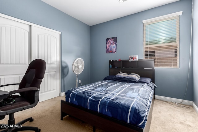 carpeted bedroom featuring a closet, baseboards, and visible vents