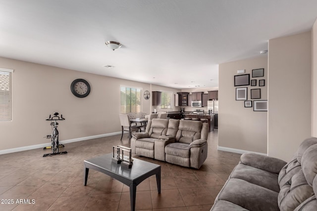 tiled living room featuring baseboards