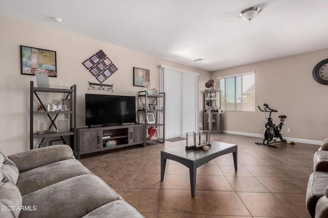 living area featuring baseboards, visible vents, and tile patterned floors