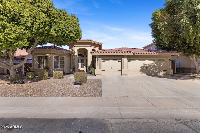 mediterranean / spanish home featuring a garage