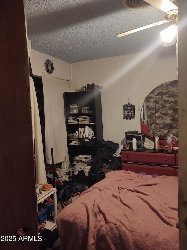 bedroom with a textured ceiling and ceiling fan