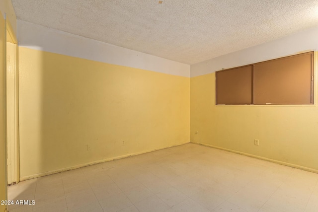 6120 N 30th Ave, Phoenix, AZ 85017 - empty room featuring a textured ceiling and light floors