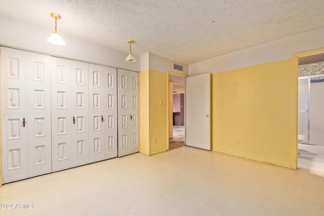 6120 N 30th Ave, Phoenix, AZ 85017 - unfurnished bedroom featuring a textured ceiling and a closet