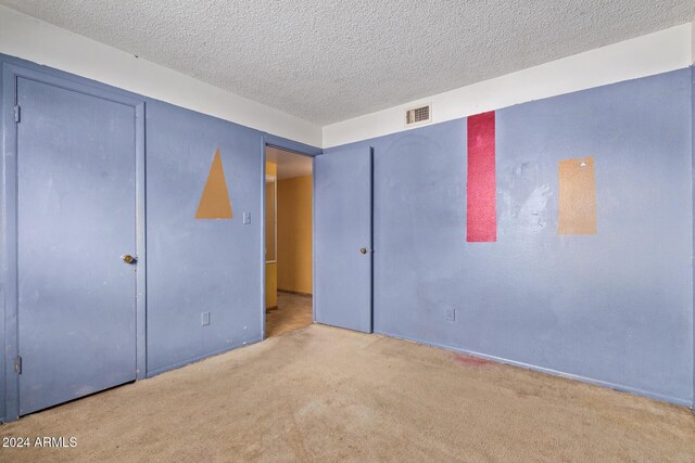 6120 N 30th Ave, Phoenix, AZ 85017 - unfurnished bedroom featuring carpet flooring and a textured ceiling