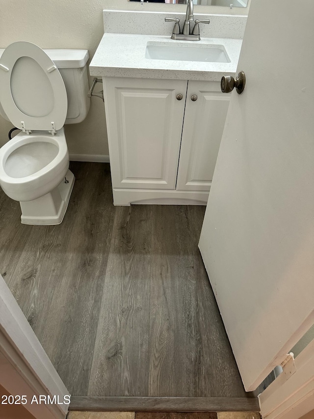 6120 N 30th Ave, Phoenix, AZ 85017 - bathroom with wood finished floors, toilet, vanity, and baseboards