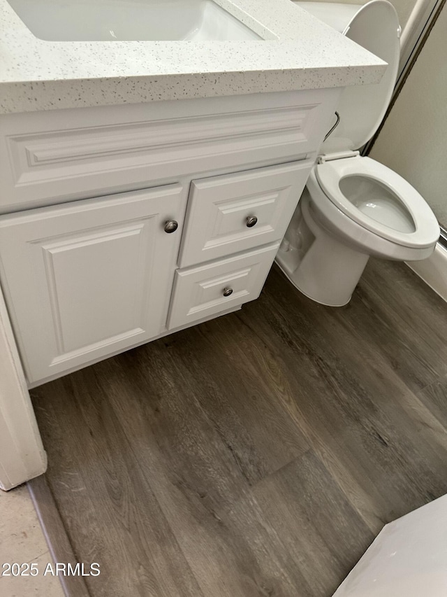 6120 N 30th Ave, Phoenix, AZ 85017 - bathroom featuring wood finished floors, vanity, and toilet
