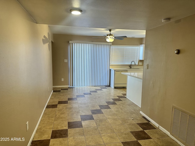 6120 N 30th Ave, Phoenix, AZ 85017 - kitchen featuring white dishwasher, light countertops, a ceiling fan, and baseboards