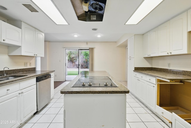 8411 E Via De Jardin, Scottsdale, AZ 85258 - kitchen with stainless steel dishwasher, a center island, black electric stovetop, light tile patterned floors, and dark countertops