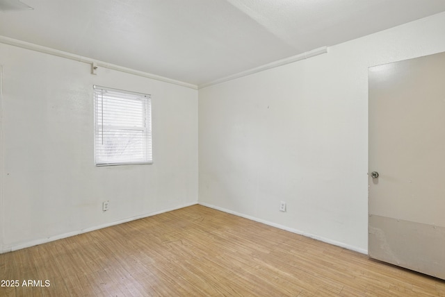 8411 E Via De Jardin, Scottsdale, AZ 85258 - spare room featuring light wood-style flooring and baseboards