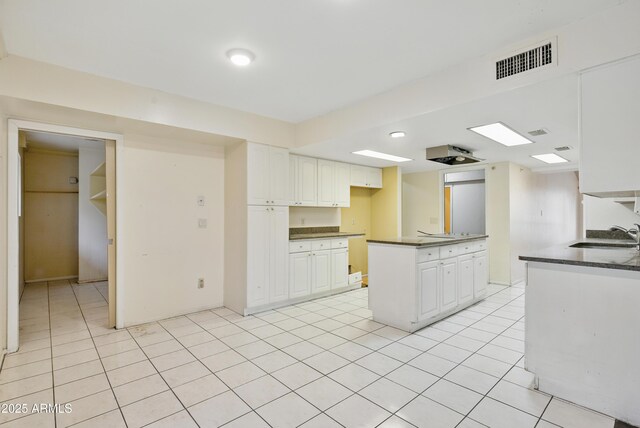 8411 E Via De Jardin, Scottsdale, AZ 85258 - kitchen featuring dark countertops, white cabinets, and light tile patterned floors