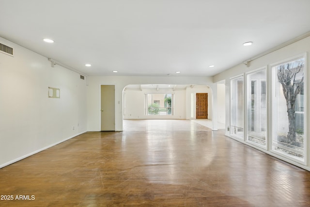 8411 E Via De Jardin, Scottsdale, AZ 85258 - unfurnished room featuring arched walkways, recessed lighting, and wood finished floors