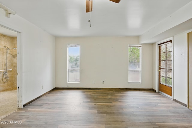 8411 E Via De Jardin, Scottsdale, AZ 85258 - unfurnished room with wood finished floors and a ceiling fan