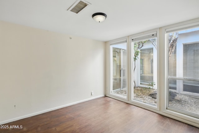 8411 E Via De Jardin, Scottsdale, AZ 85258 - unfurnished room featuring wood finished floors and baseboards