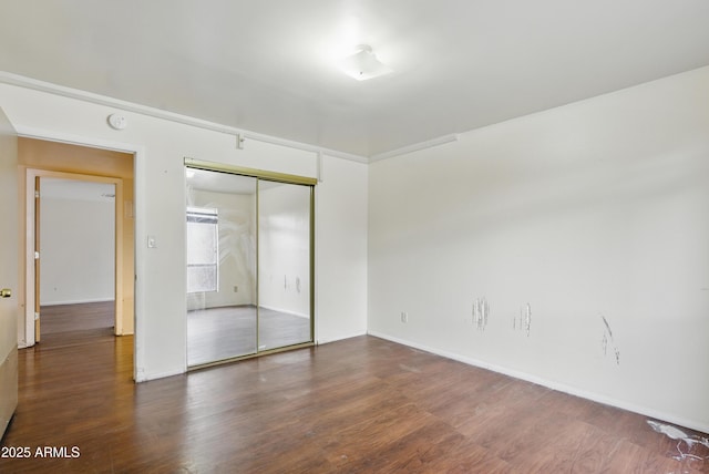 8411 E Via De Jardin, Scottsdale, AZ 85258 - unfurnished bedroom with wood finished floors and a closet