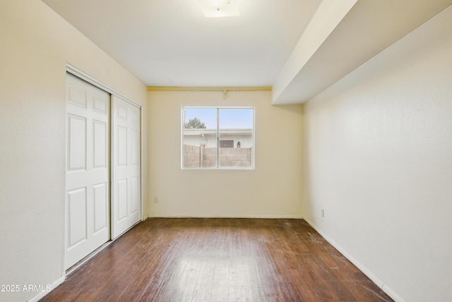 8411 E Via De Jardin, Scottsdale, AZ 85258 - unfurnished bedroom with wood finished floors and a closet
