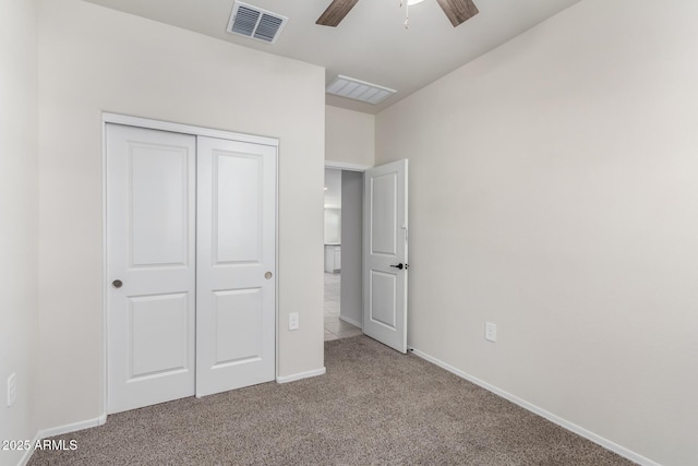 unfurnished bedroom with baseboards, a closet, visible vents, and light colored carpet