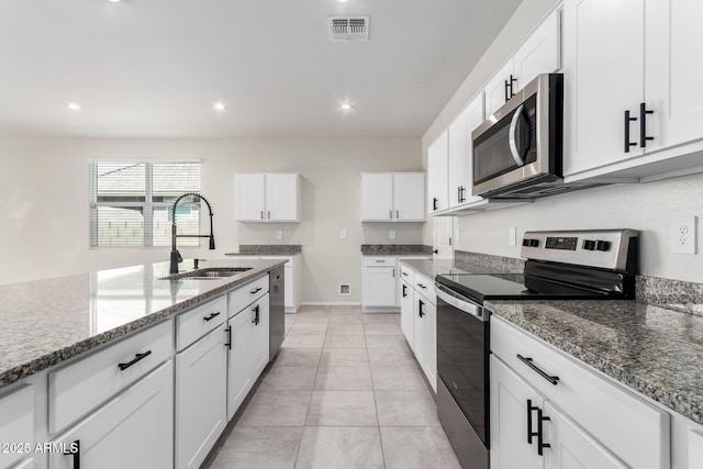 kitchen featuring white cabinetry, visible vents, appliances with stainless steel finishes, and a sink