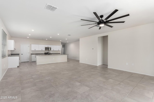 unfurnished living room featuring ceiling fan