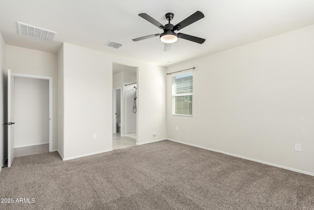 unfurnished bedroom featuring light carpet, baseboards, visible vents, and ceiling fan