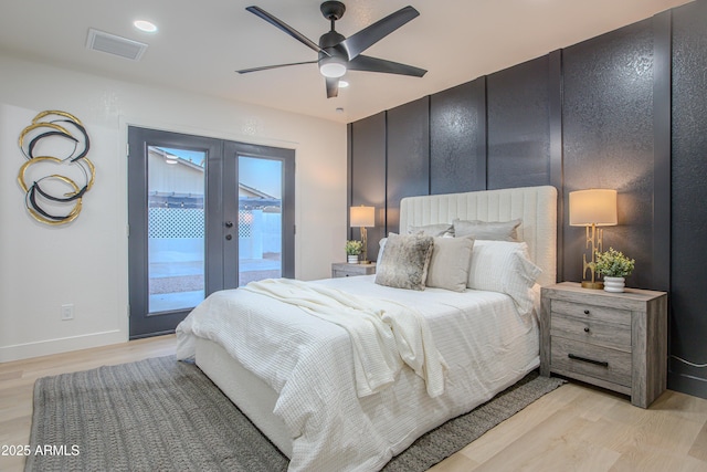 bedroom with access to exterior, french doors, ceiling fan, and light wood-type flooring