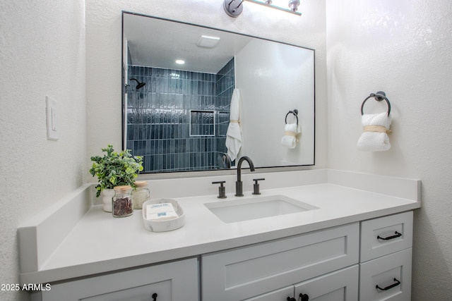 bathroom featuring vanity and a tile shower