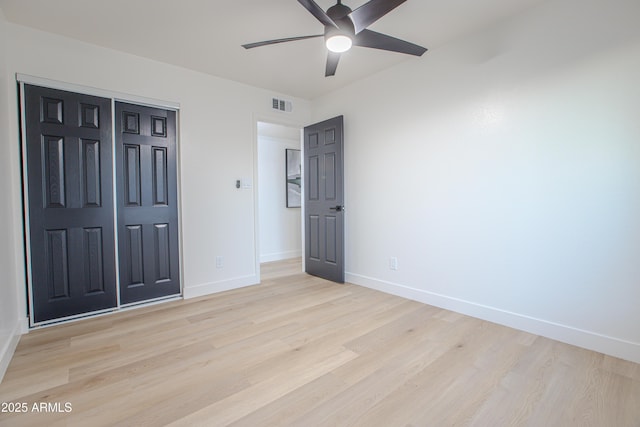 unfurnished bedroom with ceiling fan, light hardwood / wood-style floors, and a closet