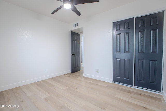 unfurnished bedroom featuring a closet, ceiling fan, and light wood-type flooring