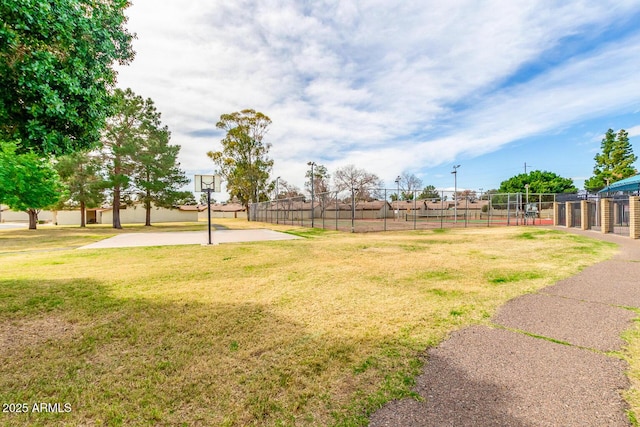 view of yard featuring basketball hoop