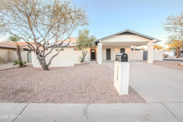 ranch-style home featuring a carport