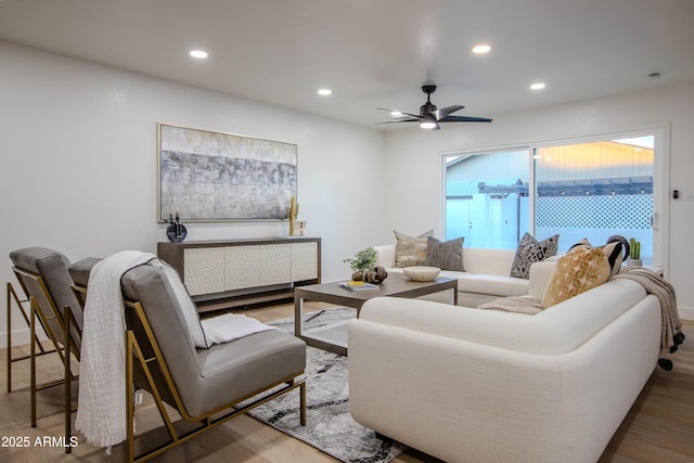 living room with wood-type flooring and ceiling fan