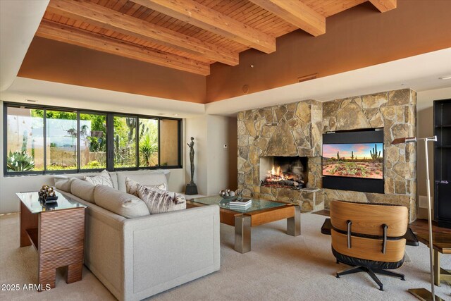 3120 Arroyo Hondo, Carefree, AZ 85377 - carpeted living area with beamed ceiling, a stone fireplace, and wooden ceiling