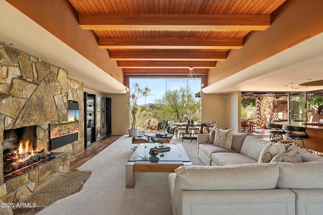 3120 Arroyo Hondo, Carefree, AZ 85377 - living area with a fireplace, beam ceiling, wooden ceiling, and wood finished floors
