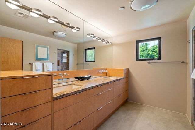 3120 Arroyo Hondo, Carefree, AZ 85377 - bathroom with double vanity, visible vents, baseboards, and a sink