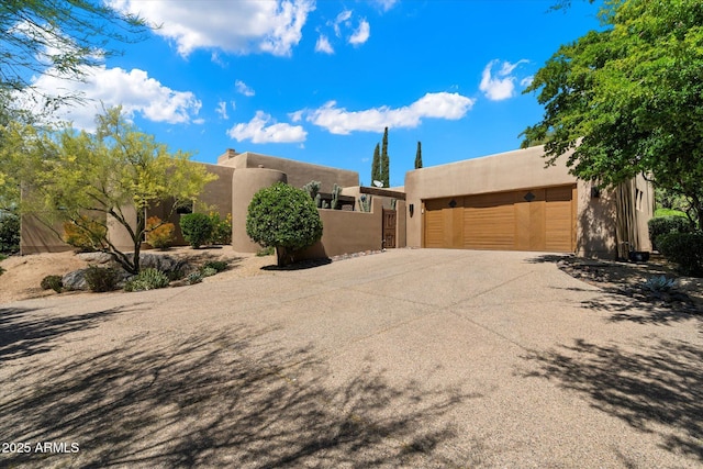 3120 Arroyo Hondo, Carefree, AZ 85377 - pueblo-style home featuring stucco siding, driveway, and a garage