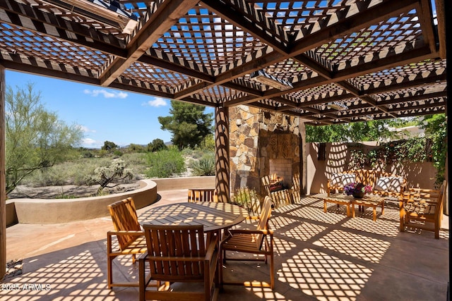 3120 Arroyo Hondo, Carefree, AZ 85377 - view of patio / terrace featuring outdoor dining area, fence, an outdoor stone fireplace, and a pergola