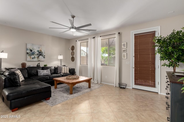 living room with light tile patterned floors, baseboards, and ceiling fan