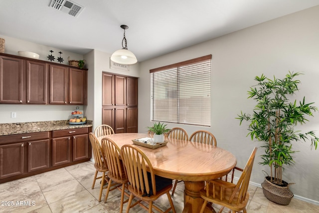 dining space featuring visible vents and baseboards