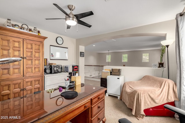 kitchen with open floor plan, a ceiling fan, and arched walkways