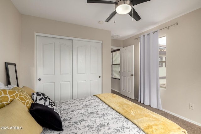 bedroom featuring a closet, baseboards, carpet, and ceiling fan